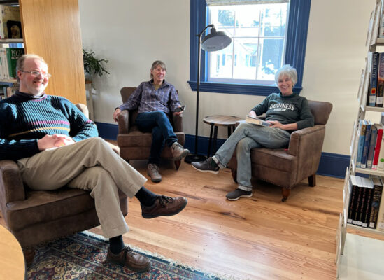 Patrons relaxing together in a sunny corner of the library